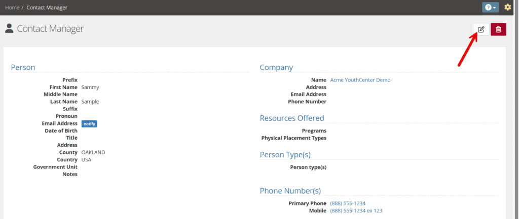 Contact Manager detail view for a person with a red arrow graphic pointing to the edit icon in the top right.